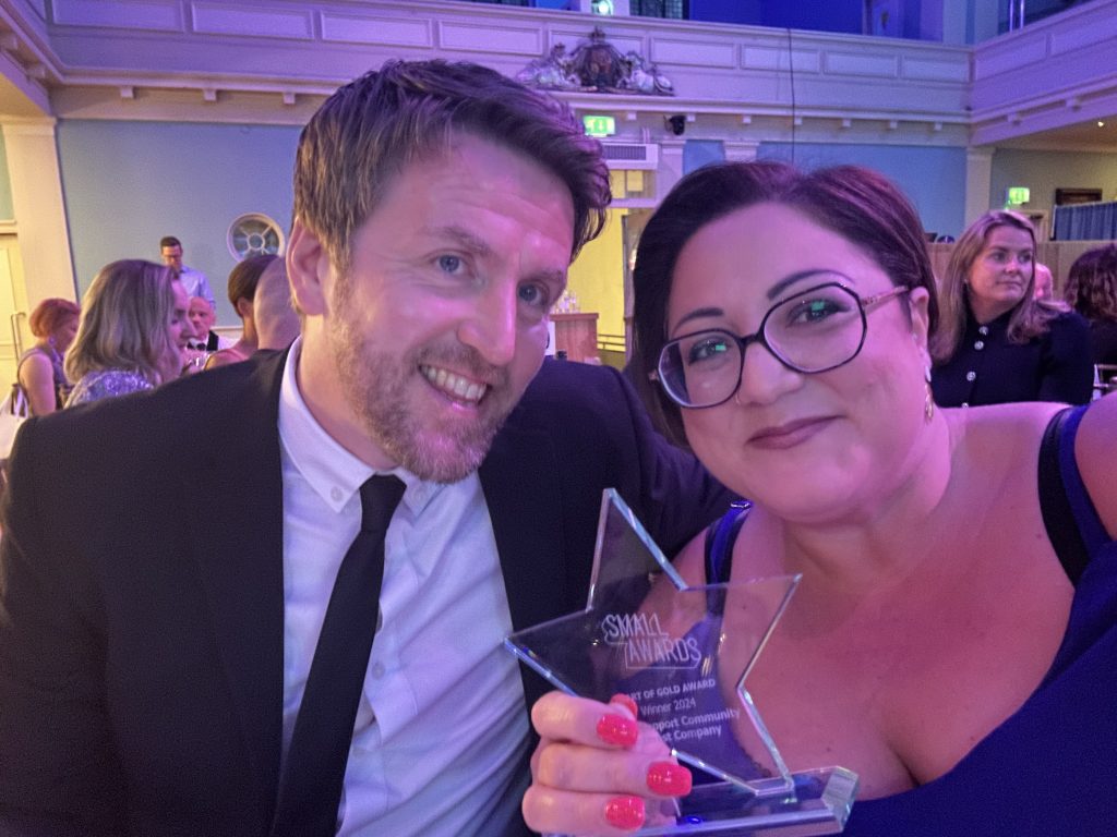 Nick Walsh and Elena Nicola holding Small Award