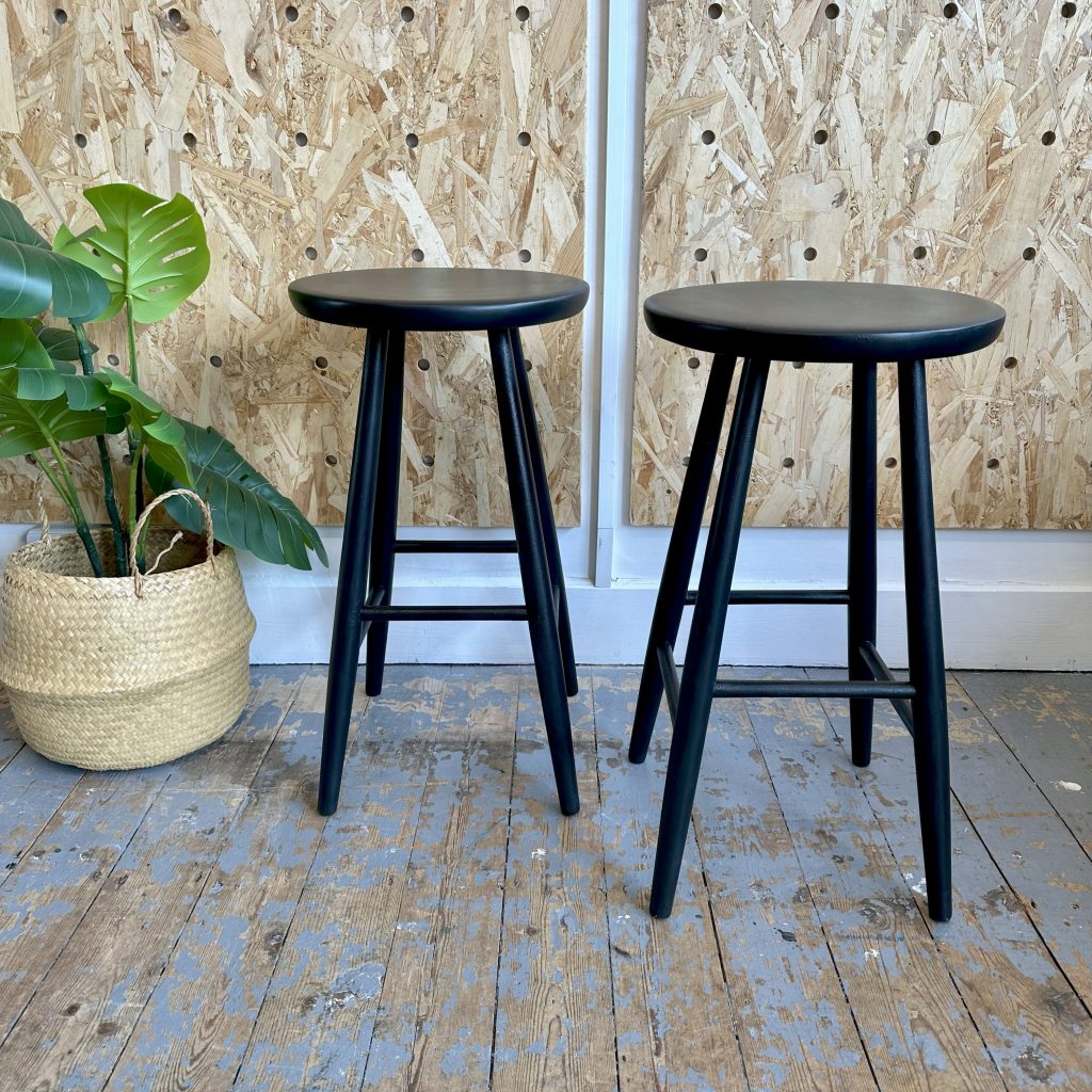 two plain black kitchen stools